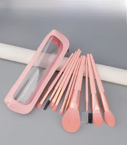 Close-up of 10 pink makeup brushes with rose gold ferrules and a matching zipper pouch