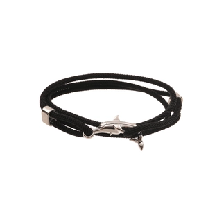 Detail of black woven rope bracelet with polished silver shark-shaped charm and metal caps