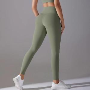 Rear view of high-waisted olive green yoga leggings showing butt-lifting seam details