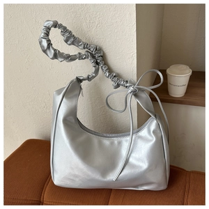 Silver metallic hobo shoulder bag with gathered scrunchie handle and cute ribbon strap detail.