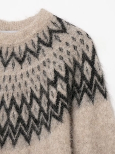 Detail of round neckline and alpaca wool texture with geometric jacquard pattern