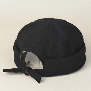 Detail of adjustable strap and fabric texture on a black cotton docker hat for men