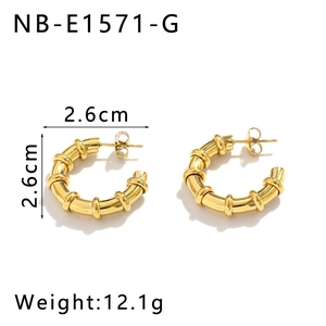 Détail de créoles en C dorées de 2,6 cm avec design texturé en forme de bambou