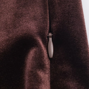 Detailed close-up of dark brown velvet dress featuring high-quality invisible zipper