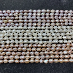 Macro shot of assorted 5-9mm rice-shaped natural freshwater pearls in purple and pink tones