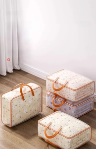 Detail view of large storage bag with orange handles and breathable mesh fabric