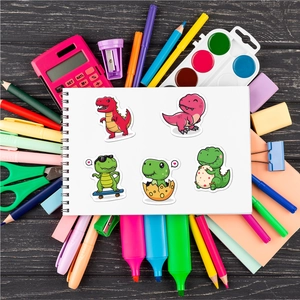 Close-up of waterproof dinosaur stickers on a notebook with colorful stationery accessories