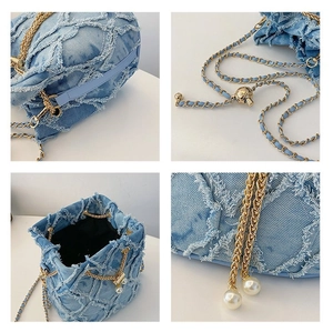 Detailed views of light blue denim bucket bag with frayed edges and golden pearl charms