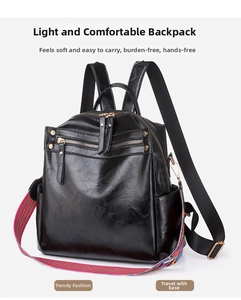 Close-up of black leather backpack featuring a colorful striped woven shoulder strap