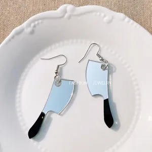 Creative Halloween mirror acrylic knife dangle earrings displayed on a white ceramic plate