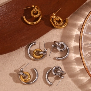 Detail view of 18K gold and silver plated stainless steel knotted hoop earrings collection