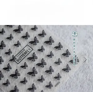 Detail of KX058 5D nail stickers featuring dark black butterfly designs and text