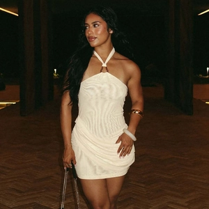 Detail of beige halter mini dress with ripple texture, pleats and metal ring neckline