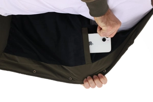 Detail of an olive green jacket featuring a large internal pocket holding a smartphone