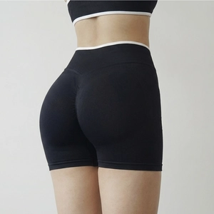 Detail of seamless scrunch butt yoga shorts with white contrast trim and ribbed texture