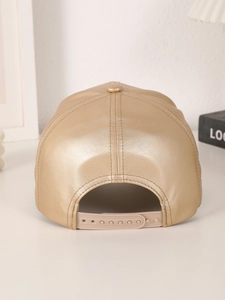 Detail view of the adjustable plastic buckle and metallic gold PU leather on the baseball cap