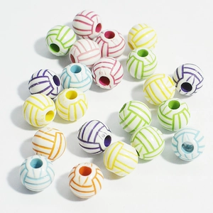 Macro shot of colorful acrylic volleyball-shaped beads for handmade DIY jewelry crafting