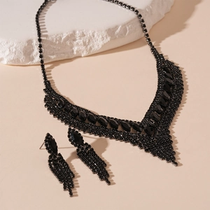 Detailed view of luxury black rhinestone V-shaped necklace and matching tassel earrings set