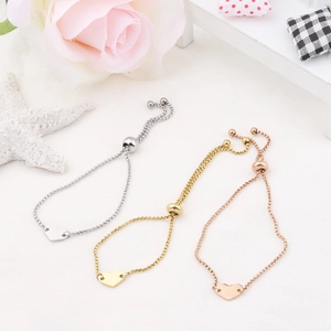 Adjustable heart charm bracelets in silver, gold, and rose gold with slide clasps