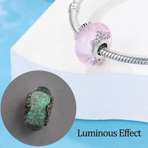 Luminous paw print charm on snake chain with pink glass bead glowing in the dark
