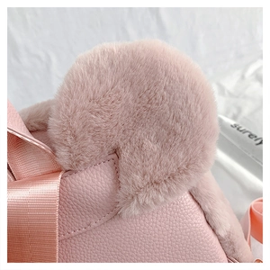 Detail of pink plush ear and lychee grain PU leather texture on a backpack