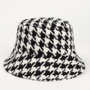Close-up of thick houndstooth pattern fabric on a stylish winter bucket hat for women