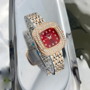 Detail view of the red square dial and diamond-set bezel on the dual-tone link watch