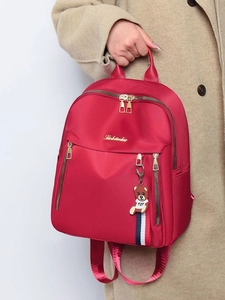 Red stylish women's nylon backpack with bear pendant and large capacity for travel