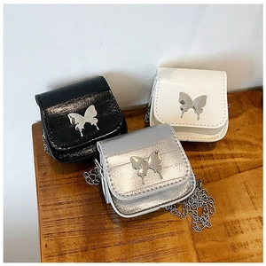 Detail view of mini saddle bags in black white and silver with metal butterfly buckle