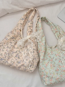 Floral canvas tote bags with delicate lace bow details in cream and green colors