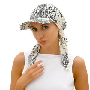 Detailed view of the soft paisley fabric and back tie design on a white turban hat