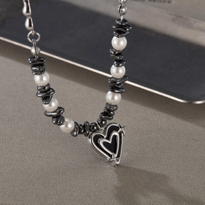 Titanium steel necklace with white pearls, black stones and silver heart pendant