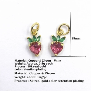 Macro shot of 15mm strawberry charms with pink heart zirconia and green marquise stones