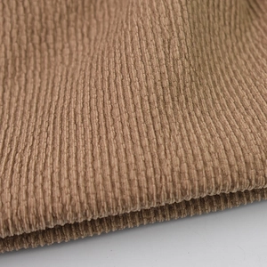 Detailed macro view of the premium khaki corduroy fabric with vertical ribbed texture