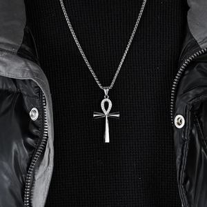 Silver Ankh cross necklace with clear stones worn by model on a black jacket