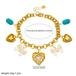Gold-plated charm bracelet featuring pearl bow, blue stone, and heart pendants on white background