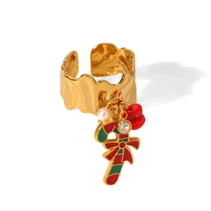 Detail of Christmas ring with candy cane, pearl, and rhinestone charms on gold hammered band