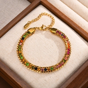 Detail of gold curb chain bracelet with colorful zircons, K18 hallmark, and lobster clasp