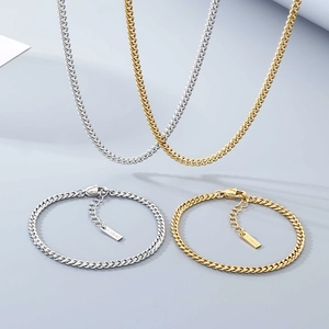 Matching set of gold and silver stainless steel Cuban link necklaces and bracelets