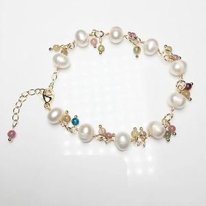 Detailed shot of handmade freshwater pearl bracelet with colorful tourmaline gemstones