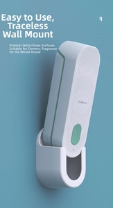 Detail of a white wall-mounted smart fragrance diffuser with the word Delicious on blue wall