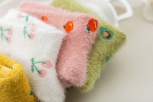 Close-up of four colorful plush mink fleece socks with cute fruit patterns and soft texture