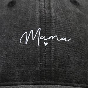 Close-up of Mama text and heart embroidery on washed denim vintage baseball cap