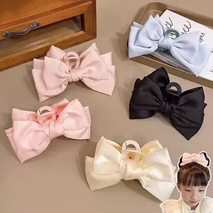 Large satin bow hair clips for girls in blue, pink, black and cream white colors