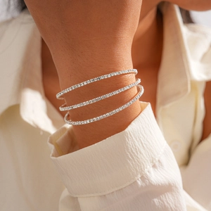Detail of silver triple-layer tennis bracelet with sparkling zircon stones on wrist