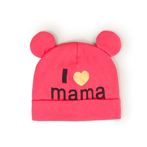 Close-up of pink baby knitted hat with cute ears and I Love Mama gold heart print