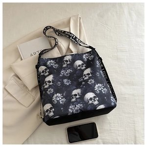 Detail of black nylon crossbody bag with skull floral prints and 'LOVE' strap