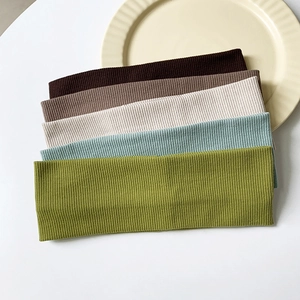 Detail of five-color ribbed knit headbands showing texture and neutral earthy tones