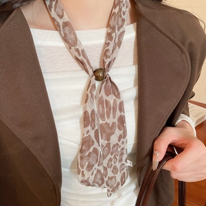Detail of leopard print chiffon necktie necklace with dark brown decorative bead buckle
