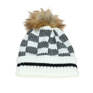 Women's autumn winter knit beanie with black and white checkerboard pattern and faux fur pom pom